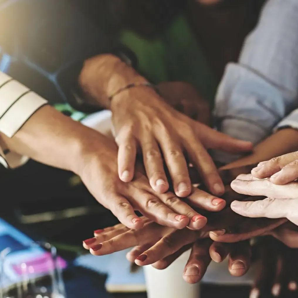 Stacked Hands in Office Meeting